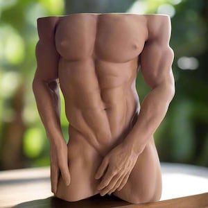 May include: A tan-colored, torso-shaped decorative planter. The planter is sculpted to resemble a muscular male figure, with defined abs, arms, and hands. The arms extend outward, and the hands are positioned near the lower abdomen. The planter has a hollowed-out top for plants.