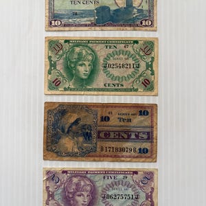 May include: Four vintage military payment certificates. The top certificate is blue and features a submarine illustration. The second and fourth certificates feature a woman's portrait. The third certificate is brown and features a woman's portrait.