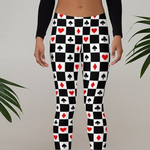 May include: Black and white leggings with a checkered pattern featuring red hearts, spades, clubs, and diamonds.