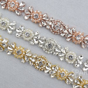 May include: Three rows of beaded trim with clear rhinestones and pearls. The top row is rose gold, the middle row is silver, and the bottom row is gold.