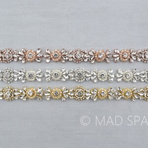 May include: Three rows of beaded trim with crystal and pearl embellishments. The trim is available in silver, rose gold, and gold.