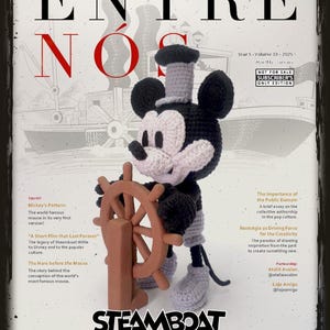 May include: A framed magazine cover featuring a crocheted Mickey Mouse in a Steamboat Willie theme. The magazine title is "ENTRE NÓS" with "STEAMBOAT WILLIE" at the bottom. The cover includes text about Mickey's pattern and the film "Last Forever".