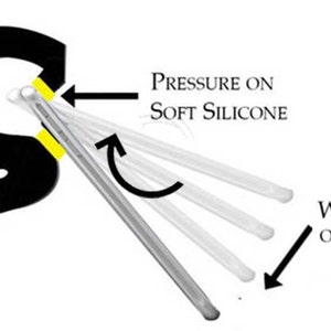 May include: A black phone stand with a yellow silicone grip. The stand is designed to hold a phone in place using the weight of the phone and pressure on the silicone grip.