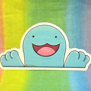 May include: A light blue cartoon sticker featuring a smiling creature with a wide pink mouth and small black eyes. The creature has two small arms and is outlined in black. The background is a rainbow gradient.