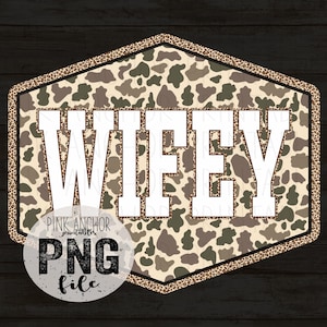 May include: A decorative sign with the word "WIFEY" in bold white letters. The sign has a camouflage pattern background and a leopard print border. A circular logo with the text "PINK ANCHOR PRINTABLES PNG file" is at the bottom.