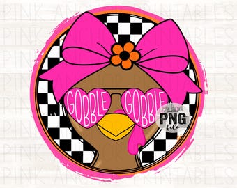 May include: A circular graphic design featuring a brown turkey wearing a large hot pink bow with an orange flower center and heart-shaped pink sunglasses with the text GOBBLE GOBBLE printed on the lenses, set against a black and white checkerboard.