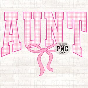 May include: A pink and white gingham patterned "AUNT" graphic with a pink bow. The text is in a bold, collegiate-style font. The image includes the text "PINK ANCHOR PRINTABLES" and "PNG file".