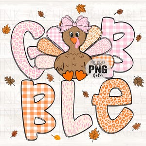 May include: A Thanksgiving-themed graphic with the word "GOBBLE" in large, colorful letters. The letters feature various patterns, including pink gingham, leopard print, and polka dots. A cartoon turkey with a pink bow sits above the letters, surrounded by autumn leaves.