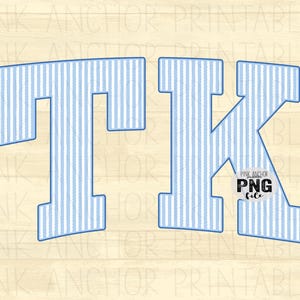 May include: The letters T and K in a collegiate block font featuring a light blue and white vertical pinstripe pattern with a dark blue outline. A small circular badge with the text PINK ANCHOR PNG file is positioned over the letter K.
