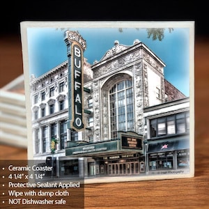 May include: A ceramic coaster featuring a photograph of Shea's Buffalo Theatre, a historic performing arts center in Buffalo, New York. The coaster is 4 1/4 inches by 4 1/4 inches.