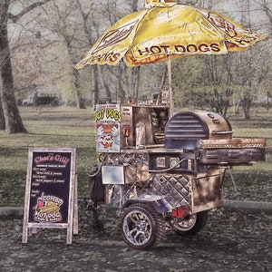 May include: A hot dog cart with a yellow umbrella that says 