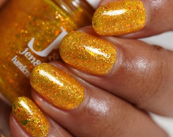 Hardcorn Punk yellow jelly Jen & Berries nail polish with red/orange/gold crystal shifting and red and gold metallic flakies for fall