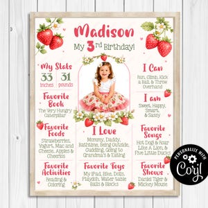 May include: A personalized birthday poster for a 3-year-old girl, featuring a photo and stats. The poster includes the child's height (33 inches) and weight (31 pounds), favorite things, and activities. Decorated with strawberries and flowers.