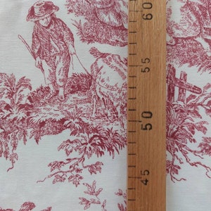 May include: Red and white toile fabric with a repeating pattern of a boy walking a sheep, trees, and birds. A wooden ruler is visible on the right side of the image.