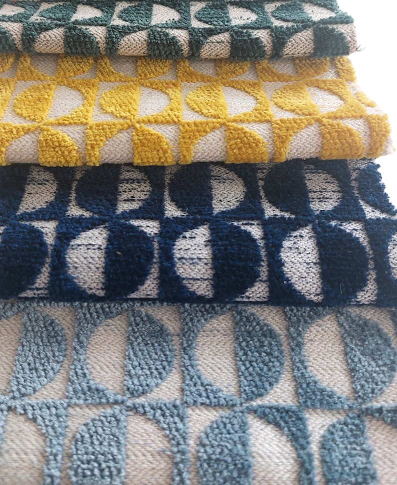 May include: Four fabric swatches with a geometric pattern of half circles. The swatches are in shades of green, yellow, blue, and light blue.