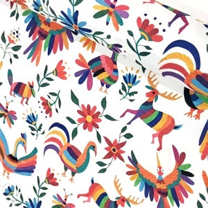 May include: White fabric with a colorful Mexican folk art pattern. The pattern features a variety of animals, including deer, birds, and roosters, all with bright rainbow colors. The background is white with green leaves and flowers.