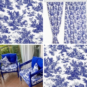 May include: Two blue upholstered chairs with white and blue patterned fabric. The chairs have wooden legs and are set against a white wall with a window behind them. The fabric features a toile pattern with a repeating design of trees, houses, and figures.