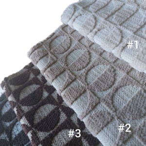 May include: Three fabric swatches with a geometric pattern of circles and squares. The top swatch is light beige, the middle swatch is a darker beige, and the bottom swatch is brown. The swatches are labeled #1, #2, and #3.