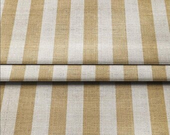 May include: Close-up of a fabric with vertical stripes in alternating beige and white. The fabric appears to be folded over at the bottom, creating a layered effect. The texture of the fabric is visible, suggesting a natural fiber.