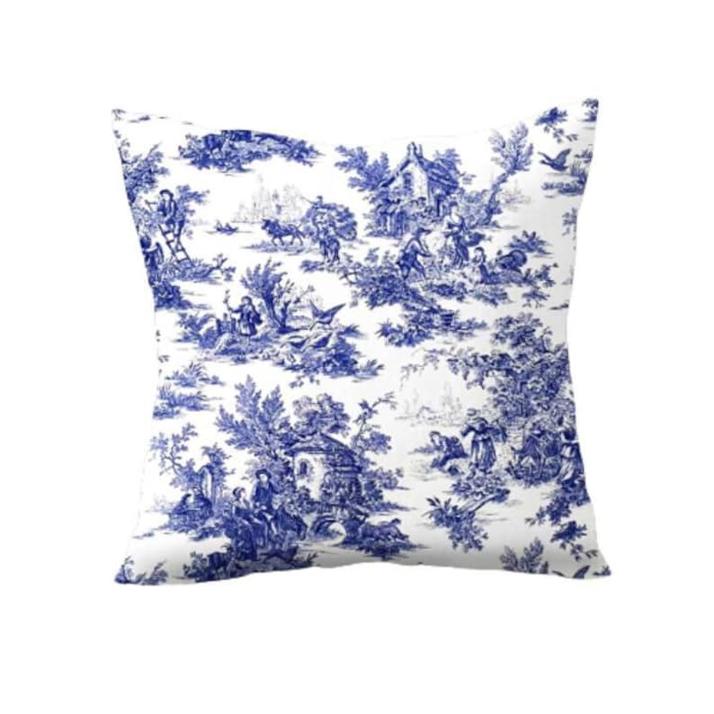 May include: Blue and white patterned throw pillow with a toile design featuring a cottage and figures in a landscape.