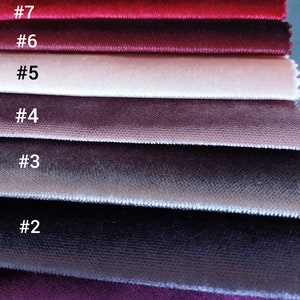May include: Eight fabric swatches in various shades of red, pink, and purple. The swatches are numbered 1 through 8.