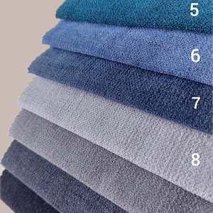 May include: A stack of fabric swatches in various shades of blue, gray, and green. The swatches are numbered 4 through 11.