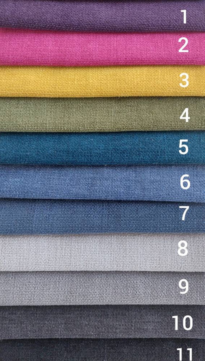 May include: A swatch card with 11 different fabric samples. The samples are arranged in a vertical row, with the numbers 1 through 11 printed next to each sample. The colors of the samples include purple, pink, yellow, green, blue, light blue, gray, dark gray, and black.