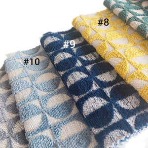 May include: Four fabric swatches with a geometric pattern. The swatches are in shades of blue, yellow, and green. The swatches are labeled #8, #9, #10.