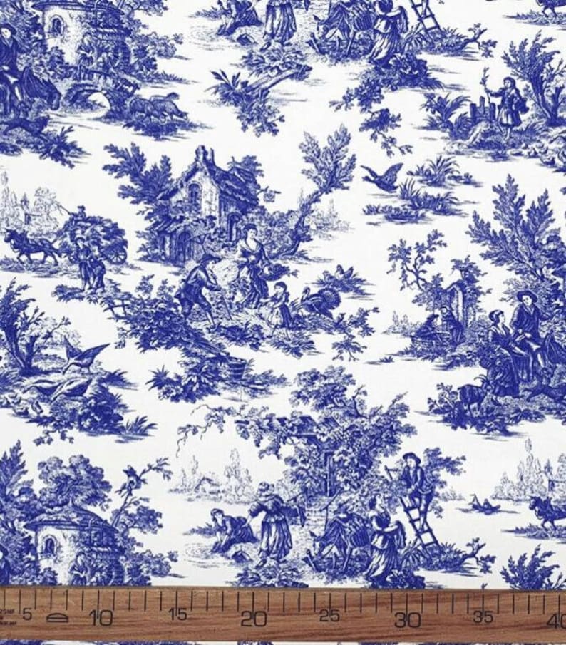 May include: Blue and white toile fabric with a repeating pattern of a French countryside scene. The pattern includes houses, trees, people, and animals. The fabric is 40 inches wide.