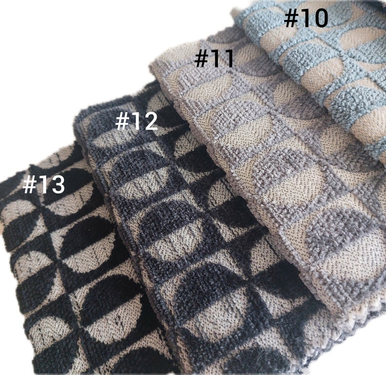 May include: Four kitchen towels with different geometric patterns. The towels are stacked on top of each other. The top towel is light blue with a white floral pattern. The second towel is gray with a white geometric pattern. The third towel is black and white with a geometric pattern. The bottom towel is black and white with a geometric pattern. The towels are labeled #10, #11, #12, and #13.