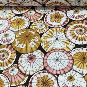 May include: A black fabric with a repeating pattern of pink and gold umbrellas. The umbrellas have a white background with black lines radiating from the center.