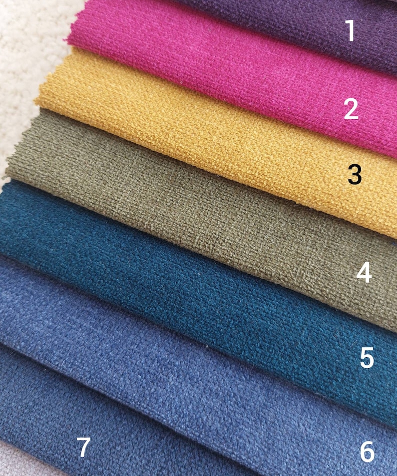 May include: A stack of seven fabric swatches in different colors, including purple, pink, yellow, green, teal, blue, and light blue. The swatches are numbered 1 through 7.