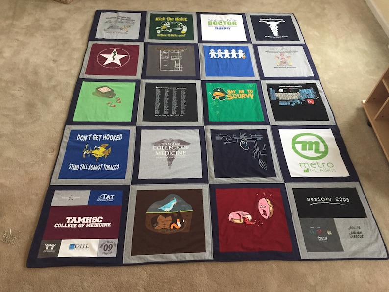 May include: A quilt made from a variety of t-shirts, featuring a variety of designs and text, including "Kick the Habit", "Doctor", "Don't Get Hooked", "Stand Tall Against Tobacco", "TAMHSC College of Medicine", "Say No to Scurvy", "Metro McAllen", and "Seniors 2003".