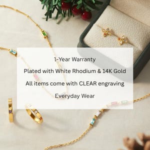 May include: Gold-plated jewelry set featuring a necklace, ring, and earrings. The necklace and bracelet have colorful gemstone accents. The earrings are flower-shaped with colorful gems. The ring has a band with colorful gems. The text in the image says "1-Year Warranty" and "Everyday Wear".
