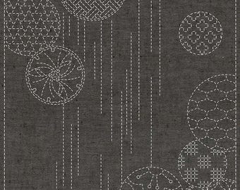 May include: A black and white geometric pattern on a dark gray background. The pattern is made up of circles with different designs, including stars, flowers, and geometric shapes.