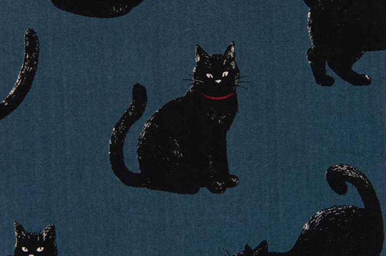 May include: A blue fabric with a repeating pattern of black cats. The cats are in various poses, some are sitting, some are standing, and some are curled up. The fabric has a subtle texture.