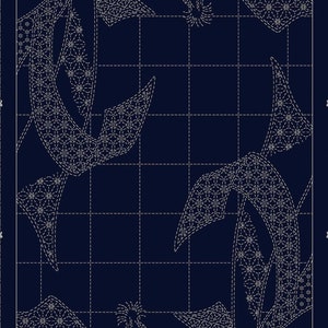 May include: A blue fabric panel with a white sashiko stitch design. The design features a repeating pattern of stylized flowers and leaves. The fabric is divided into a grid with white lines.