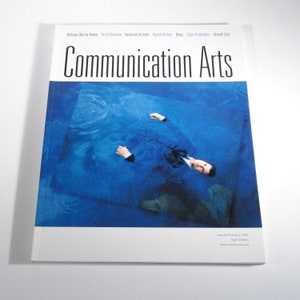 May include: A magazine titled "Communication Arts" with a cover featuring a person in a suit submerged in blue water. The magazine's title is in large black letters. The cover also includes the text "January/February 2005" and "Eight Dollars."