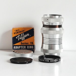 Isco-Gottingen Westar 1:4.5/100 Short Telephoto Camera Lens, Exakta Mount, for 35mm SLR Camera; Tiffen Series #6 Adapter Ring & Lens Cap