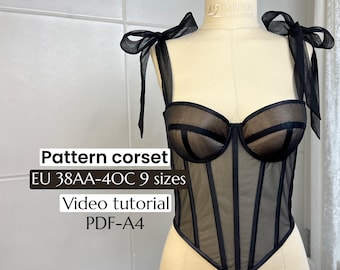May include: Black corset displayed on a mannequin. The corset features a sheer mesh design with vertical boning and a sweetheart neckline. The straps are tied with black bows. Text on the image reads "Pattern corset EU 38AA-40C 9 sizes Video tutorial PDF-A4."