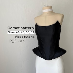May include: A black strapless corset top with a peplum hem displayed on a mannequin. Text on the image reads: Corset pattern, Size - 46, 48, 50, 52, Video tutorial, PDF - A4. The corset features vertical seams and a structured, fitted bodice.