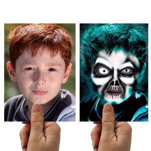 May include: Two images are held up by a hand. The first image is a portrait of a young person with red hair and freckles. The second image is a digitally altered portrait of a person with a skull face and teal hair.