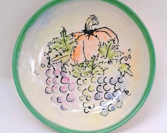 bowl with grapes and a pumpkin
