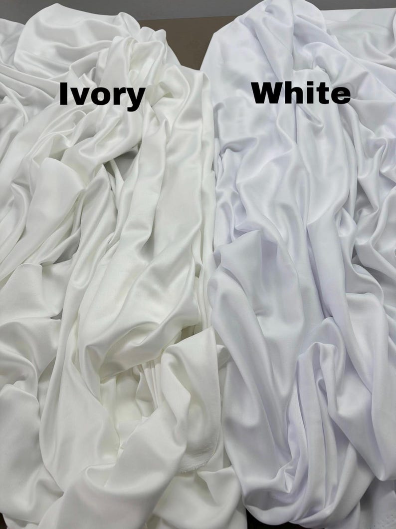 May include: Close-up of two fabric swatches, one ivory and one white. The swatches are folded and show the texture of the fabric.