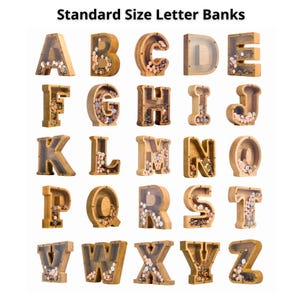 a collection of wooden letter banks, each with a different design and size, arranged in a grid-like pattern.