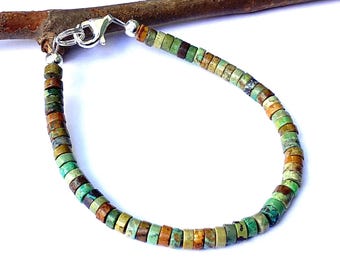 May include: A turquoise, brown, and green beaded bracelet with a silver clasp.