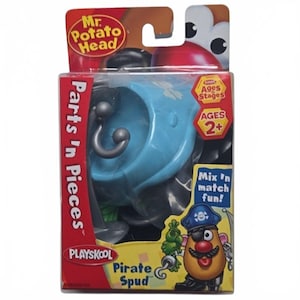 May include: A Mr. Potato Head Parts 'n Pieces Pirate Spud toy set in its original packaging. The box features a blue plastic component, a gray hook accessory, and an illustration of a potato character wearing a pirate hat and eye patch.