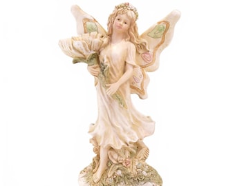 Estatua vintage de hada de 23 cm con alas de mariposa sosteniendo una flor.