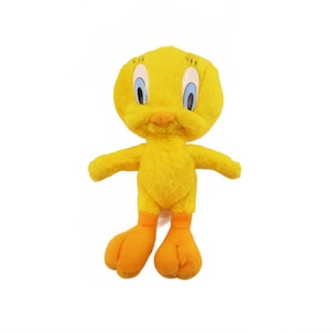 May include: A plush yellow Tweety Bird toy with orange feet and beak, and blue eyes. The stuffed animal has outstretched arms and is standing upright. The toy is a character from the Looney Tunes cartoon series.