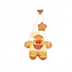 May include: A gingerbread man ornament wearing a chef's hat and apron, with a red bow tie. The apron has the word "chef" on it. Above the gingerbread man are two gingerbread cookie shapes: a heart and a star.